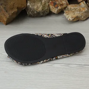 Detail view of the bottom of women's ethnic print flat slipper with non-slip rubber sole