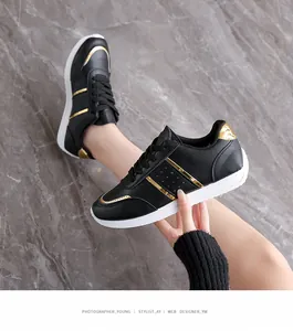 Eleganti scarpe da ginnastica casual da donna nere con strisce dorate e suole bianche