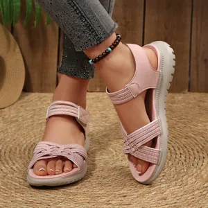 Close-up of pink sporty platform sandals with Velcro straps and woven details