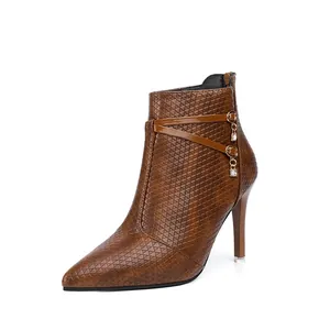 Side view of brown pointed-toe stiletto boots with elegant crystal charms and textured finish.