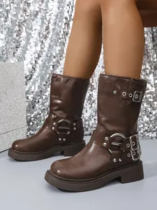 Detailed view of brown faux leather square-toe biker boots with decorative buckles