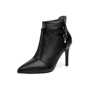 Detailed side view of black pointed toe stiletto ankle boot with elegant rhinestone chain