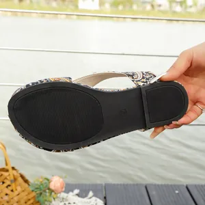 Detailed macro view of the non-slip black rubber sole on ethnic flat sandals