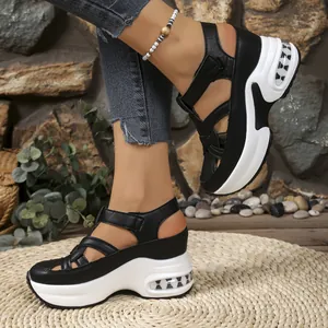 Close-up of black and white platform sandals with velcro straps and air cushion sole
