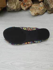 Detail view of the black non-slip rubber sole on ethnic print flat sandals size 37