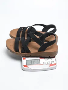 Detail view showing women's elastic strap sandal weight of 314.6g on a scale.