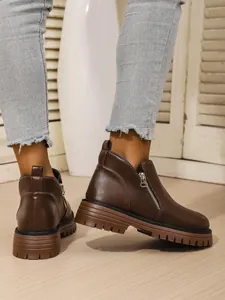 Detailed side view of women's brown thick-sole Martin boots featuring a functional side zipper
