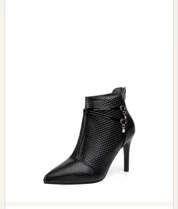 Side view of elegant black stiletto ankle boots with textured finish and rhinestone accents