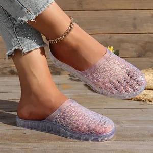 Close-up detail of stylish purple glitter hollow out jelly slippers on rustic wooden deck