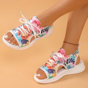 Détail de sandales de sport fleuries avec lacets blancs et semelle plateforme souple.