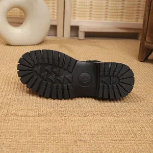Macro view of the thick non-slip rubber sole pattern on a stylish black winter fashion boot