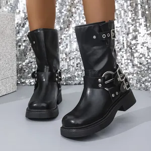 Close-up of black chunky heel Martin boots with silver buckle straps and square toe.