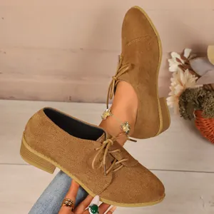 Stylish brown corduroy pointed-toe casual lace-up shoes for women presented on feet