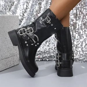 Close-up of black retro square toe short boots featuring multiple stylish silver buckles