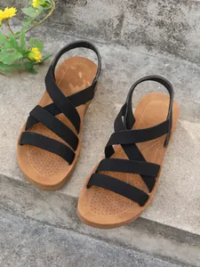 Detail view showing black elastic cross straps on comfortable summer flat sandals