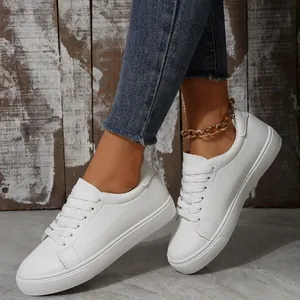 Casual low-top white sneakers for women with lace-up design and flat sole. Quality look.