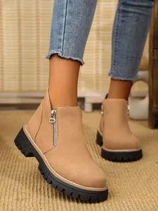 Elegant khaki suede ankle boots with side zipper and chunky black lug sole detail
