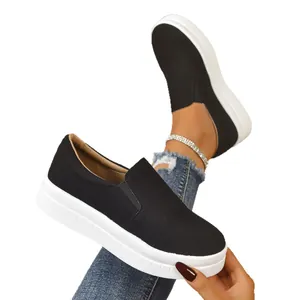 Women's black suede slip-on sneakers with thick white platform soles for casual wear