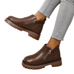 Stylish women's brown leather ankle boots with chunky rubber soles and side zippers