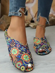 Close-up detail of bohemian mandala floral print flat sandals with cross straps for women
