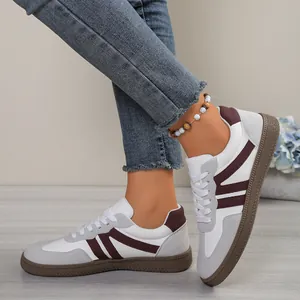 Stylish women's German army trainer sneakers featuring maroon stripes and durable gum soles