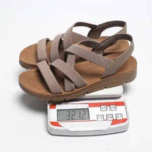 Weight measurement of brown women's cross-strap sandals showing 321.2g on a scale