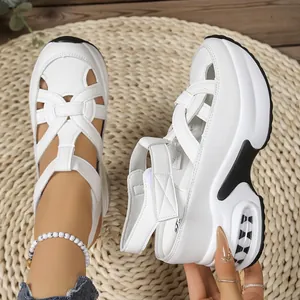 Detailed view of white platform sandals featuring a closed-toe design and adjustable velcro straps