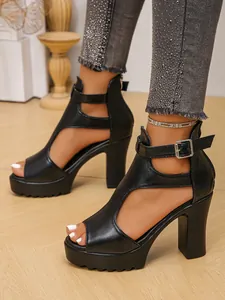 Close-up of black platform high-heel sandals with peep-toe and buckle ankle strap.