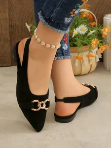 Elegant black pointed toe flats with gold chain buckle and slingback design.