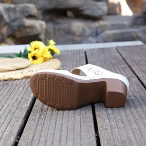 Detailed view of the non-slip sole and chunky heel on white summer mule sandals