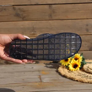 Detailed view of the anti-slip grid sole on transparent purple summer jelly slippers for women