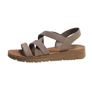 Side view of comfortable women's Roman style flat sandals with brown elastic straps