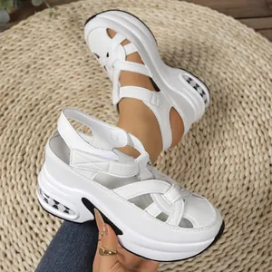 Detailed macro view of white closed-toe platform sandals with secure velcro straps