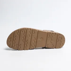 Detailed view of the brown non-slip wavy pattern sole on women's flat sandals size 37