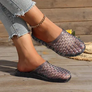 Detailed close-up showing the hollow-out texture and thick sole of grey jelly slippers.