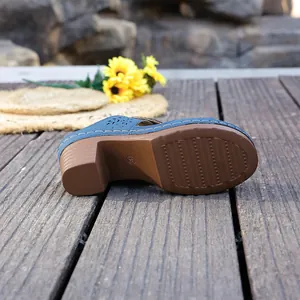 Detailed side view of blue block heel summer sandal featuring a non-slip textured brown sole