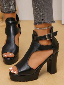 Close-up of black platform chunky high heel Roman sandals with peep toe design.