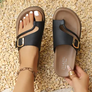 Close-up of comfortable women's platform slippers with buckle detail in black and brown