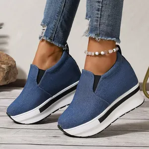 Vista detallada de las zapatillas con plataforma de mezclilla azul y suela blanca