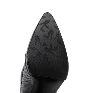 Close-up detail of the anti-slip sole on black pointed-toe high-heeled boots