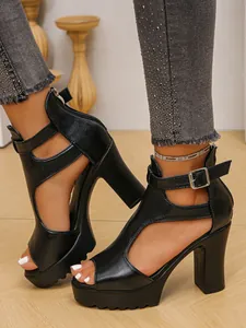Detailed side view of black platform sandals with chunky high heels and ankle buckle strap