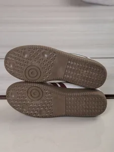 Detailed close-up view of brown rubber non-slip soles on women German Army Trainer sneakers