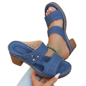 Stylish blue chunky heel sandals for women featuring elegant laser-cut floral patterns