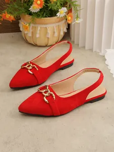 Detailed view of red pointed toe slingback flats with decorative gold chain