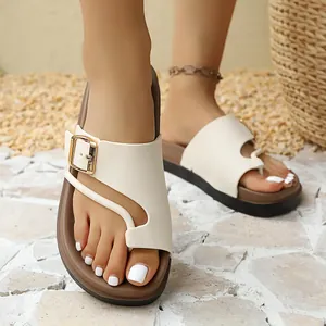 Stylish women's beige platform slide sandals featuring a gold buckle and brown footbed.