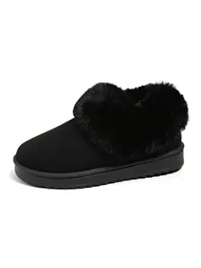 Detailed view of women's black snow boot with fluffy faux-fur collar and thick sole