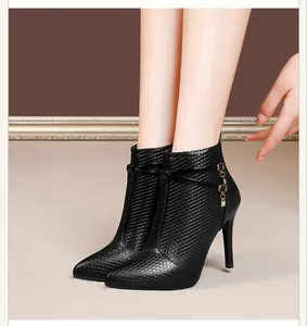 Elegant black pointed-toe stiletto ankle boots with textured grid pattern and rhinestone.