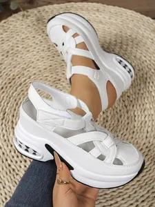 Close-up of white platform sandals with woven straps and chunky air-cushion sole.