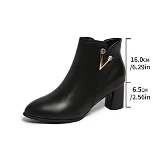 Black pointed-toe ankle boots with chunky high heel and rhinestone V ornament detail