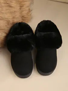 Detailed macro shot of black faux fur lining and suede texture of women's snow boots